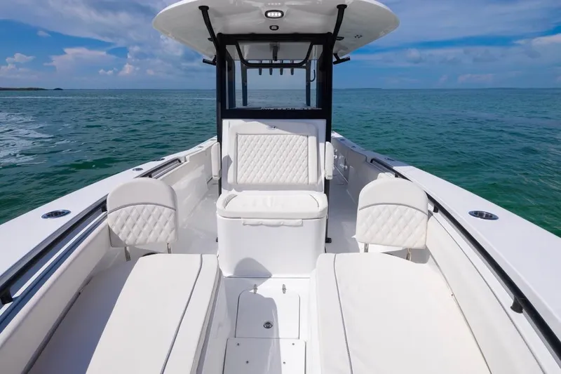 Slide: The Image of 2026 Sea Hunt Gamefish 28 Forward Seating boat on open water, showcasing luxurious interior. - 10
