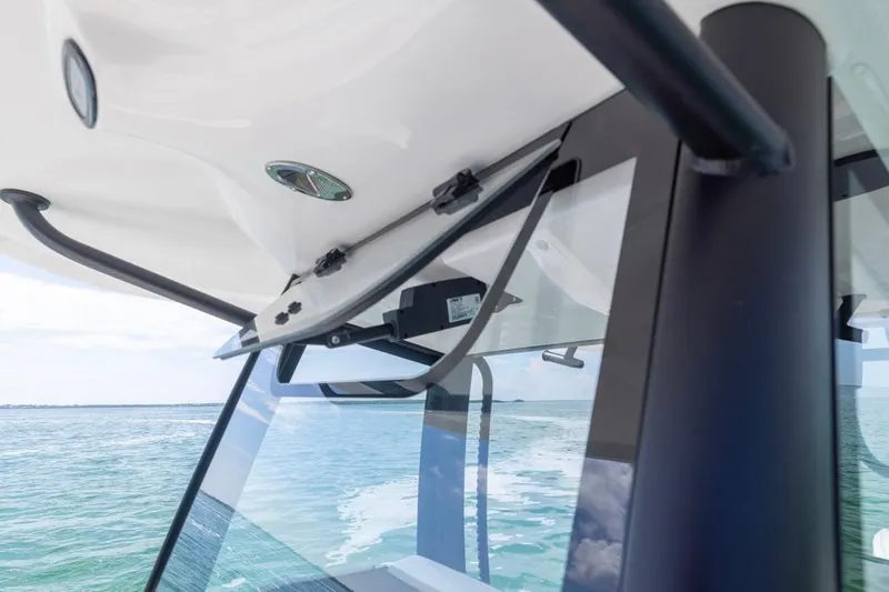 Slide: The Image of Close-up of 2026 Sea Hunt Gamefish 28 windshield, showcasing sleek design and ocean view. - 16
