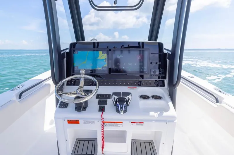 Slide: The Image of 2026 Sea Hunt Gamefish 28 helm with modern navigation system on open water. - 17