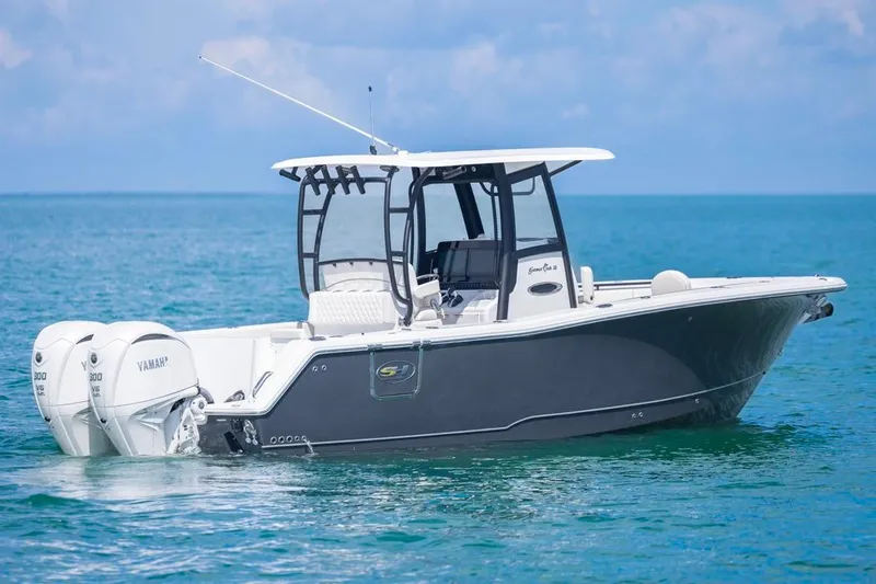 Slide: The Image of 2026 Sea Hunt Gamefish 28 Forward Seating boat on calm ocean waters. - 2