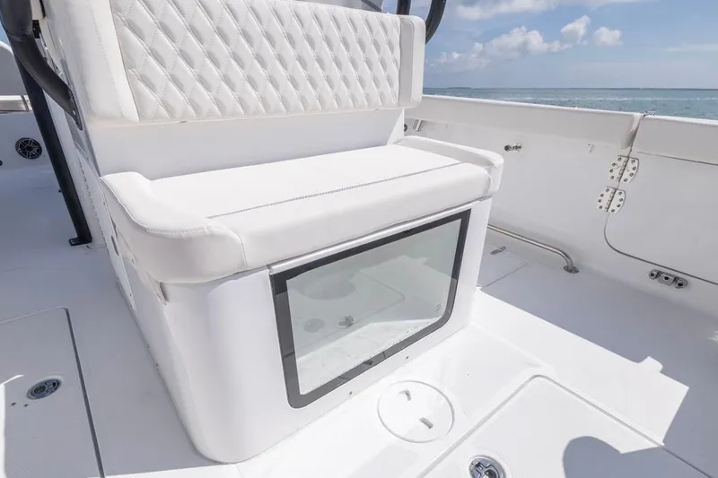 Slide: The Image of 2026 Sea Hunt Gamefish 28 Forward Seating boat interior with white cushioned seating. - 23