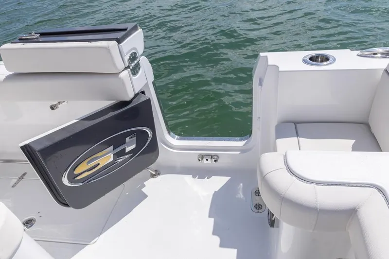 Slide: The Image of 2026 Sea Hunt Gamefish 28 boat with open side door and seating, on water. - 25