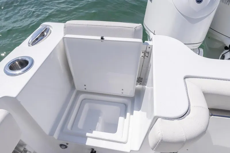 Slide: The Image of 2026 Sea Hunt Gamefish 28 Forward Seating boat interior with open storage compartment. - 26