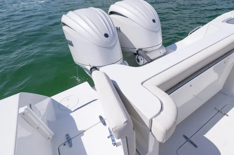 Slide: The Image of 2026 Sea Hunt Gamefish 28 boat with dual outboard motors on calm water. - 27