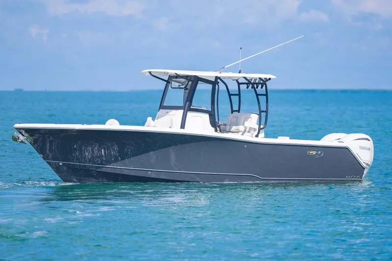 Slide: The Image of 2026 Sea Hunt Gamefish 28 Forward Seating boat on calm blue water. - 4
