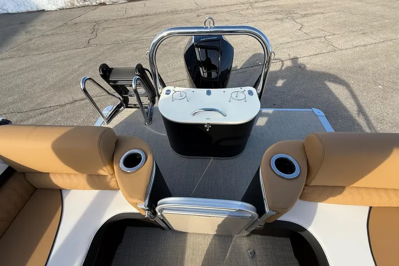 Slide: The Image of 2025 Tahoe 2585 boat interior with tan seating and cup holders, featuring a sleek design. - 10