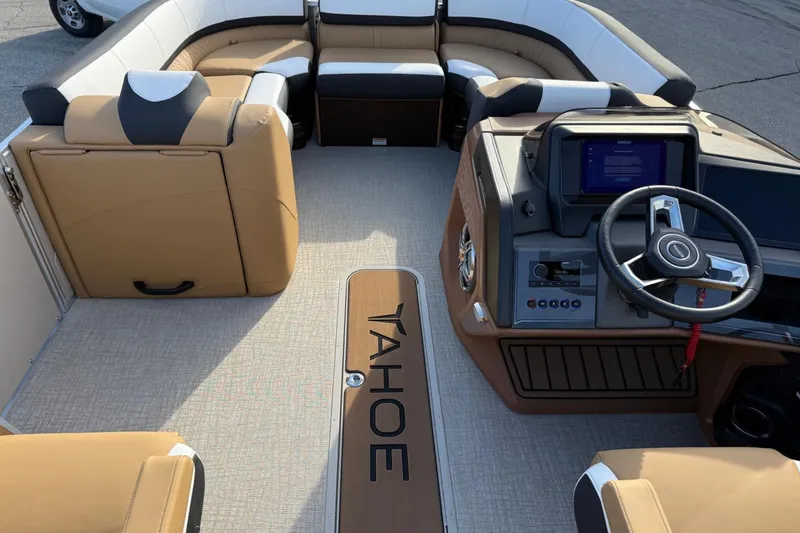 Slide: The Image of Interior of 2025 Tahoe 2585 boat with modern dashboard and comfortable seating. - 12