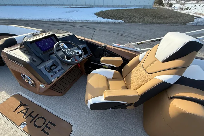 Slide: The Image of Luxurious 2025 Tahoe 2585 boat interior with modern steering console and comfortable captain's chair. - 14