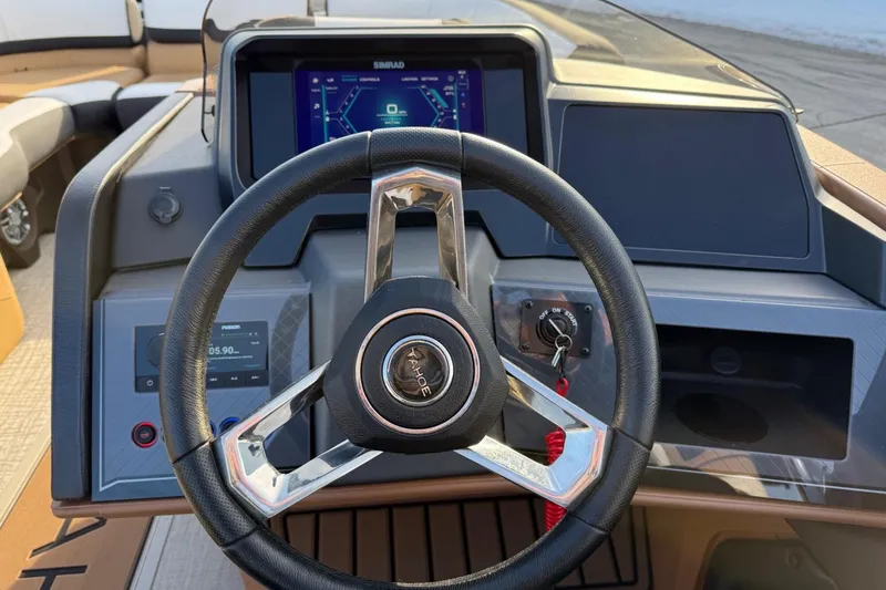 Slide: The Image of Steering wheel and dashboard of 2025 Tahoe 2585 boat with digital display. - 15