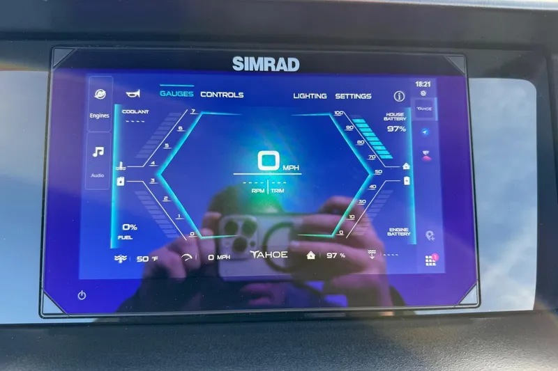 Slide: The Image of Simrad display in 2025 Tahoe 2585 showing gauges, controls, and battery status. - 16