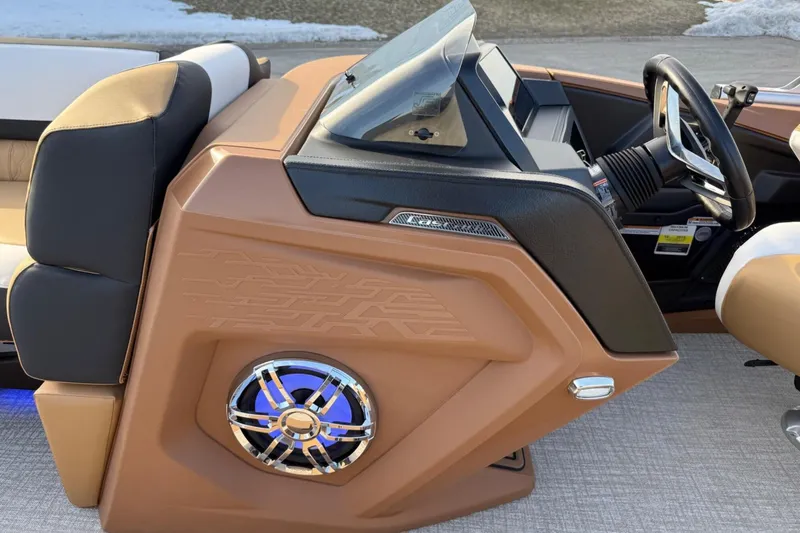Slide: The Image of 2025 Tahoe 2585 boat dashboard with modern steering and speaker system. - 17
