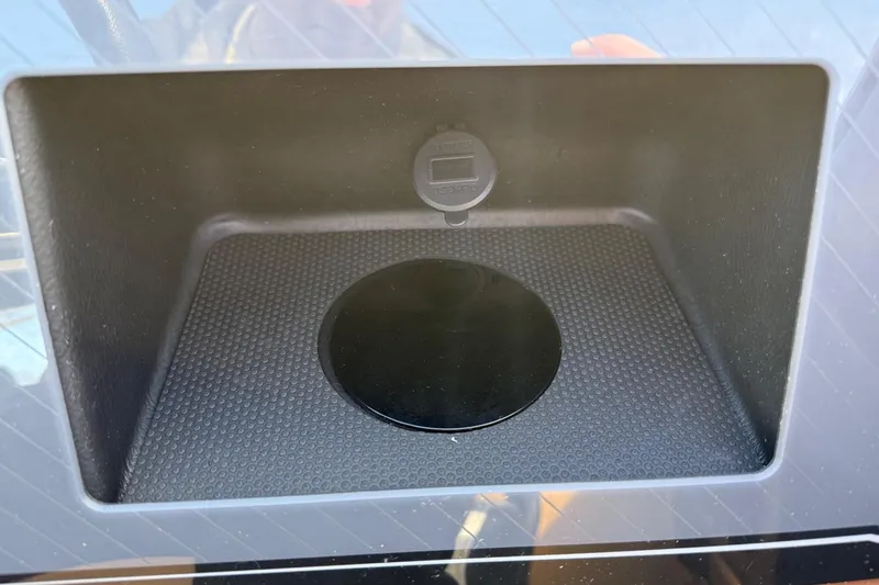 Slide: The Image of Storage compartment in 2025 Tahoe 2585 boat, featuring a textured surface and circular cover. - 22