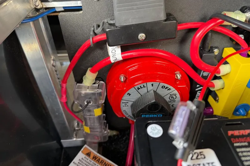 Slide: The Image of Electrical panel of 2025 Tahoe 2585 with red wiring and Perko switch. - 24