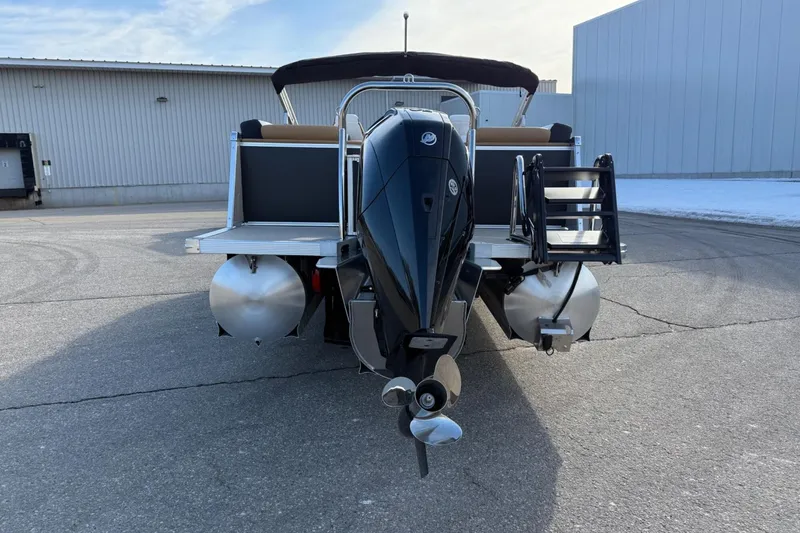 Slide: The Image of 2025 Tahoe 2585 pontoon boat with powerful outboard motor, docked on concrete surface. - 3