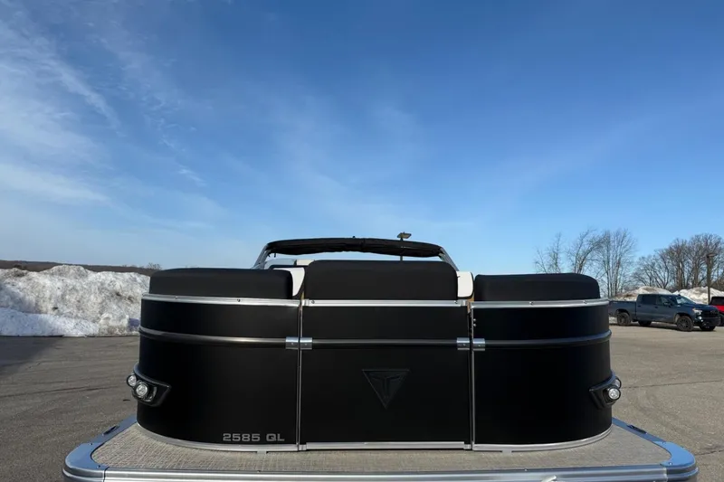 Slide: The Image of 2025 Tahoe 2585 pontoon boat in parking lot under clear blue sky. - 7