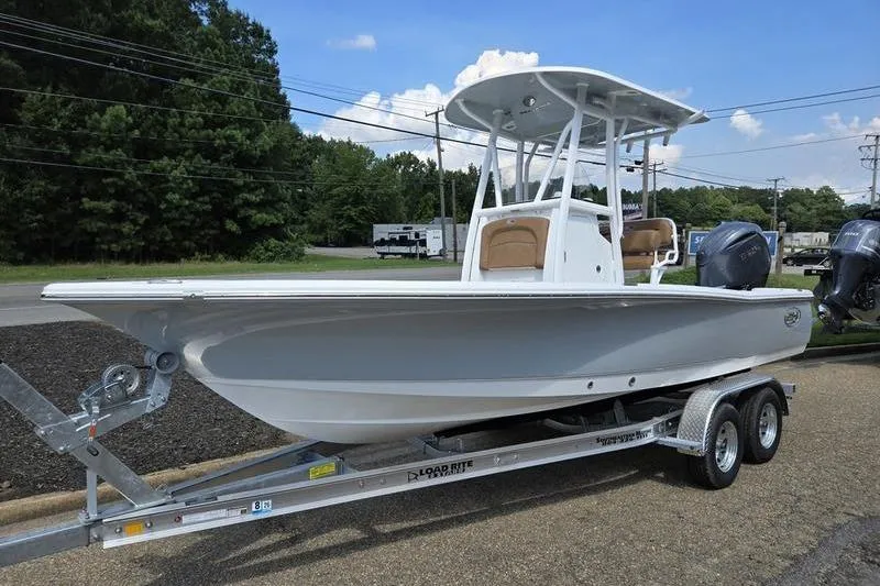 The Image of 2026 Sea Hunt BX 22 BR boat on trailer, parked outdoors under blue sky. - 1