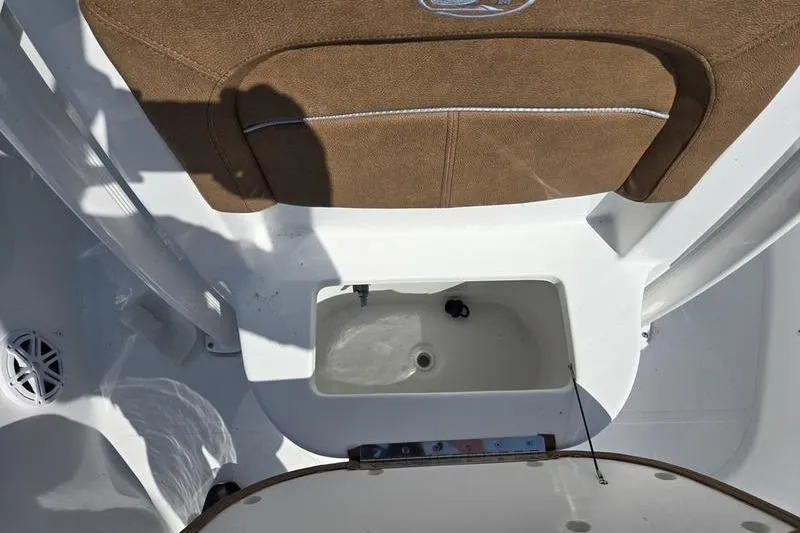 Slide: The Image of 2026 Sea Hunt BX 22 BR boat interior with storage compartment and cushioned seating. - 10