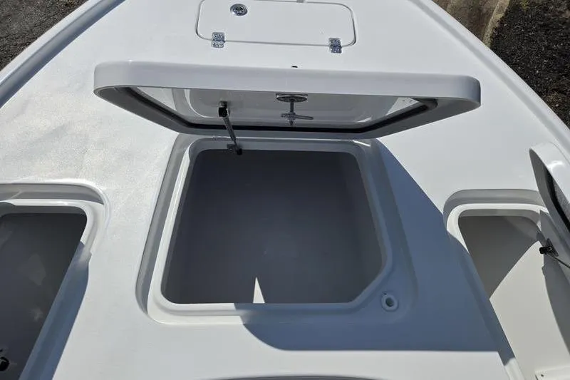 Slide: The Image of 2026 Sea Hunt BX 22 BR boat storage compartment with open hatch. - 16