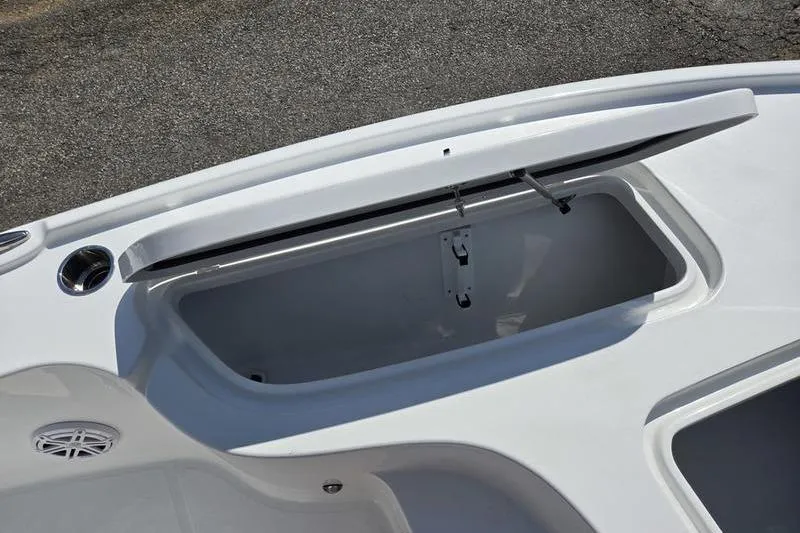 Slide: The Image of 2026 Sea Hunt BX 22 BR boat storage compartment with open lid, showcasing interior space. - 17