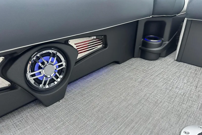Slide: The Image of 2025 Tahoe 2585 interior with speaker and cup holder, featuring modern design and lighting. - 16