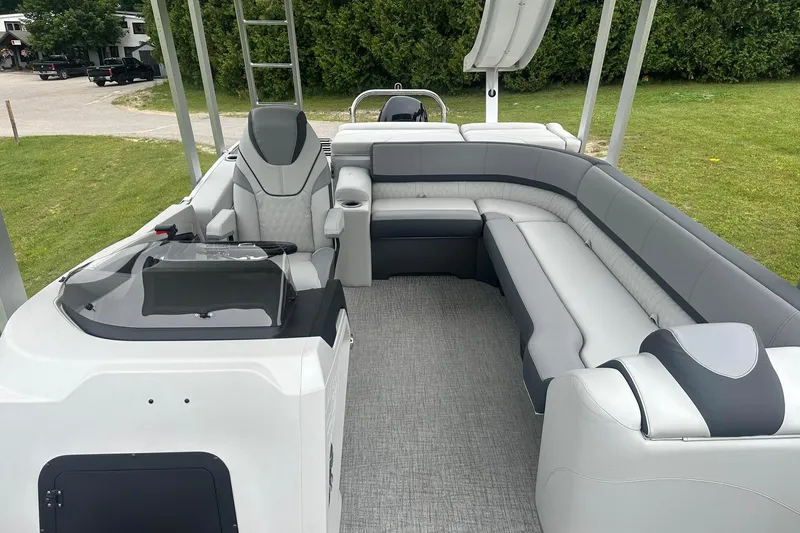 Slide: The Image of 2025 Tahoe 2585 boat interior with gray seating and modern helm design. - 17