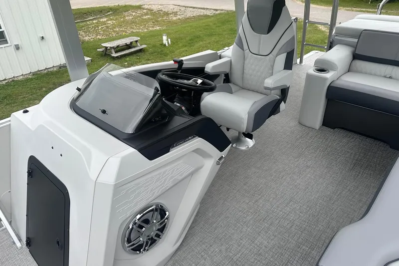 Slide: The Image of 2025 Tahoe 2585 boat interior with modern helm, luxurious seating, and sleek design. - 18