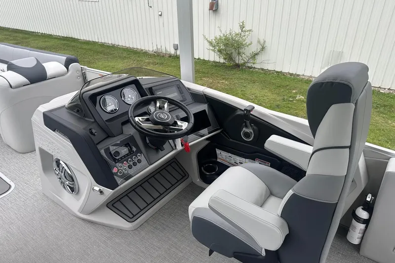 Slide: The Image of 2025 Tahoe 2585 boat interior with modern steering console and comfortable seating. - 21