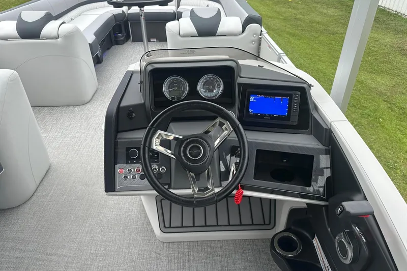 Slide: The Image of Cockpit of 2025 Tahoe 2585 boat with steering wheel and navigation display. - 22