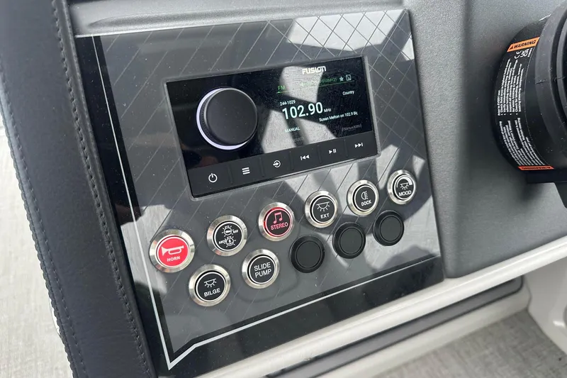 Slide: The Image of Control panel of 2025 Tahoe 2585 boat with radio and function buttons. - 23
