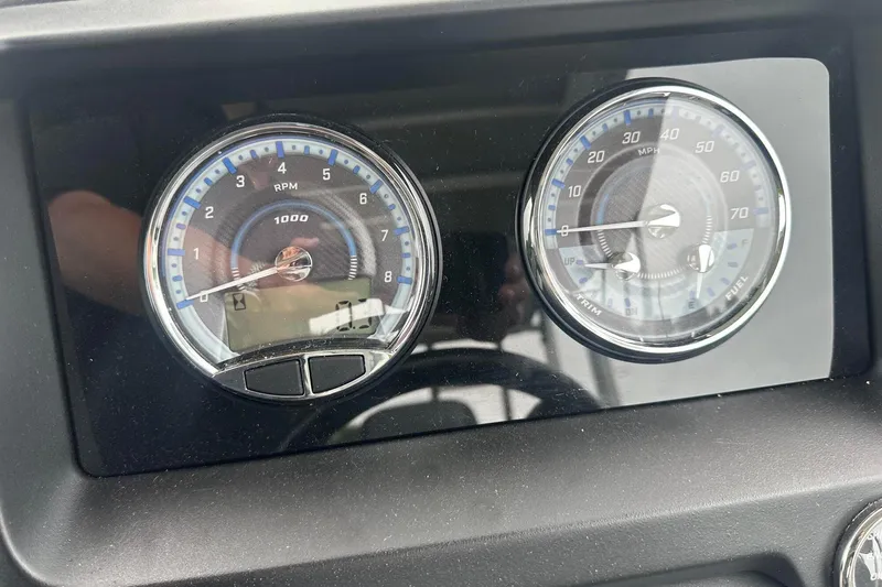 Slide: The Image of Dashboard of 2025 Tahoe 2585 showing RPM and speed gauges. - 24