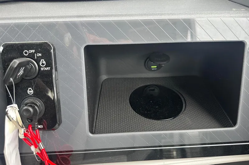 Slide: The Image of Control panel and storage compartment in 2025 Tahoe 2585 boat interior. - 27