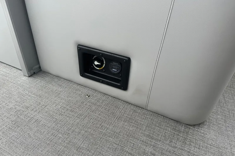 Slide: The Image of 2025 Tahoe 2585 interior with a built-in power outlet on a gray panel. - 28