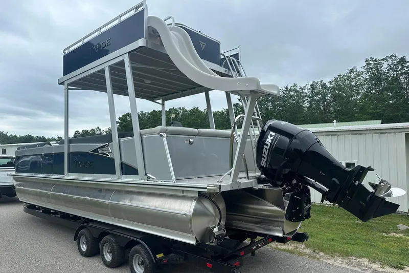 Slide: The Image of 2025 Tahoe 2585 pontoon boat with Suzuki outboard motor on trailer. - 4