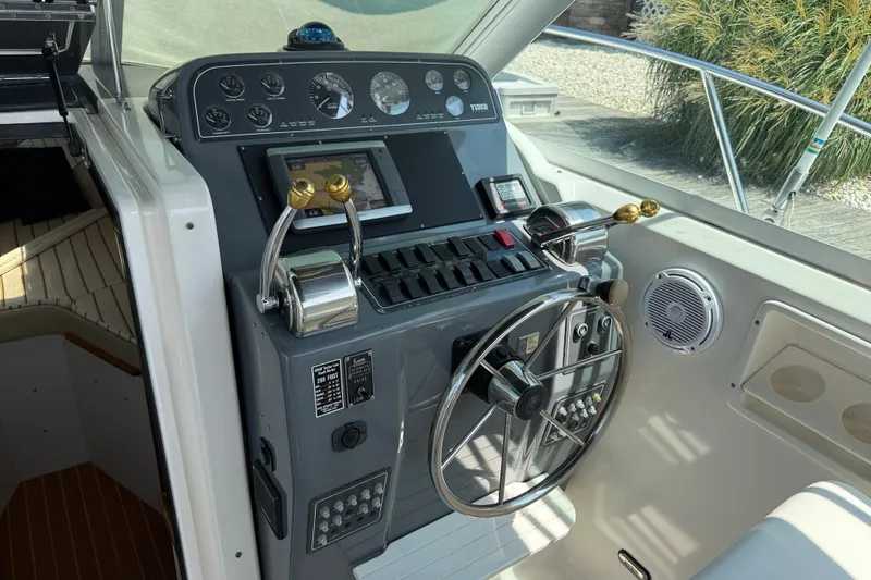 Slide: The Image of 1999 Tiara Yachts 2900 Coronet helm with steering wheel and control panel. - 13