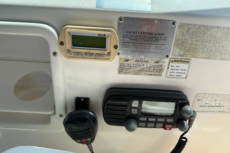 Slide: The Image of Control panel of a 1999 Tiara Yachts 2900 Coronet with radio and certification labels. - 14