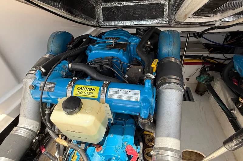 Slide: The Image of Engine compartment of a 1999 Tiara Yachts 2900 Coronet, featuring a blue marine engine. - 22