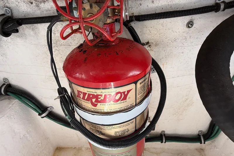 Slide: The Image of Red fire extinguisher in a 1999 Tiara Yachts 2900 Coronet engine compartment. - 23