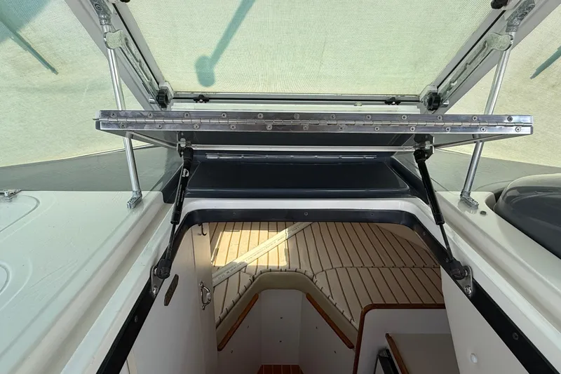 Slide: The Image of 1999 Tiara Yachts 2900 Coronet cabin entrance with open hatch and wooden flooring. - 24