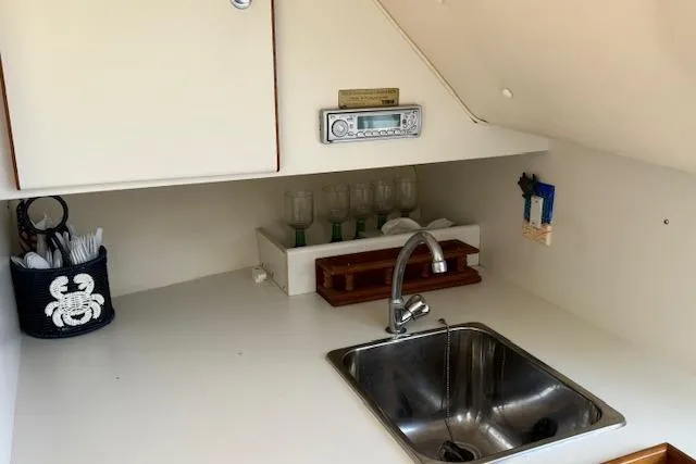 Slide: The Image of 1999 Tiara Yachts 2900 Coronet interior with sink, storage, and radio. - 26