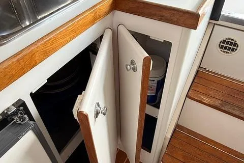 Slide: The Image of 1999 Tiara Yachts 2900 Coronet interior cabinet with wooden trim and open doors. - 28