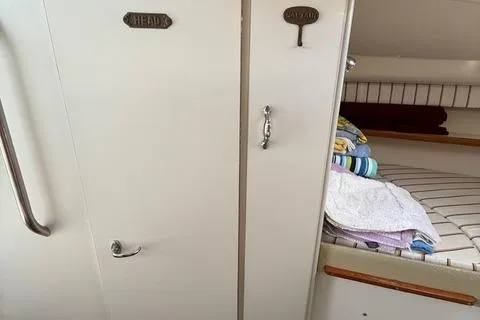 Slide: The Image of 1999 Tiara Yachts 2900 Coronet interior with storage and bedding area. - 29