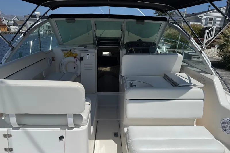 Slide: The Image of 1999 Tiara Yachts 2900 Coronet interior with white seating and helm, dockside view. - 4