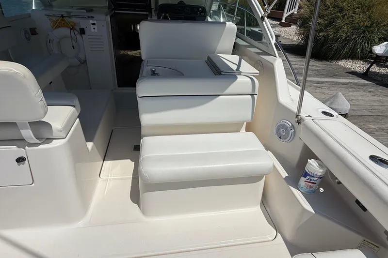 Slide: The Image of 1999 Tiara Yachts 2900 Coronet interior with white seating and deck details. - 5