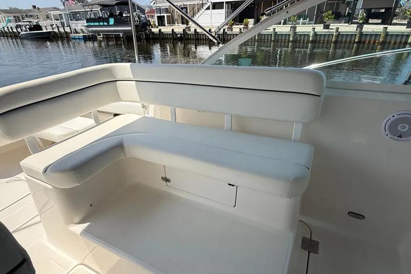 Slide: The Image of 1999 Tiara Yachts 2900 Coronet interior seating, docked by waterfront homes. - 7