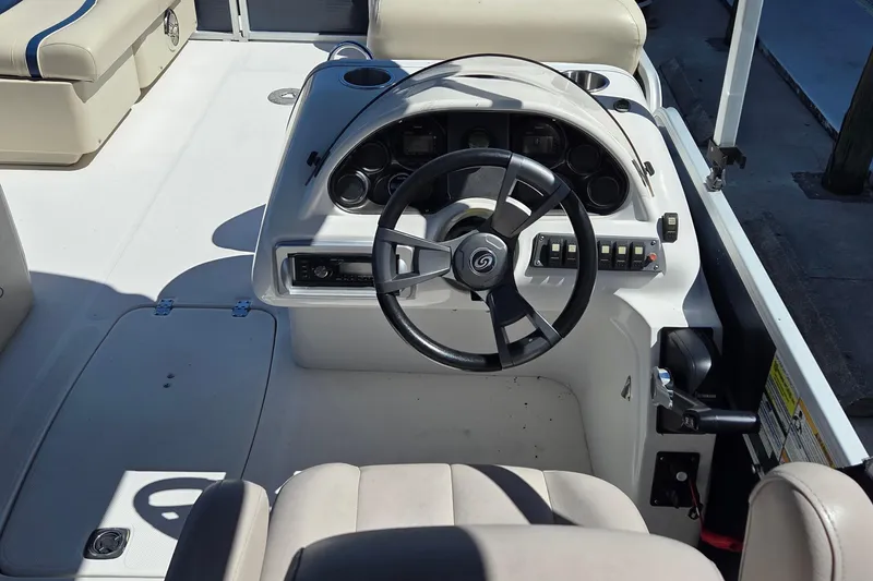 Slide: The Image of 2014 Hurricane FunDeck 216 OB boat cockpit with steering wheel and control panel. - 10
