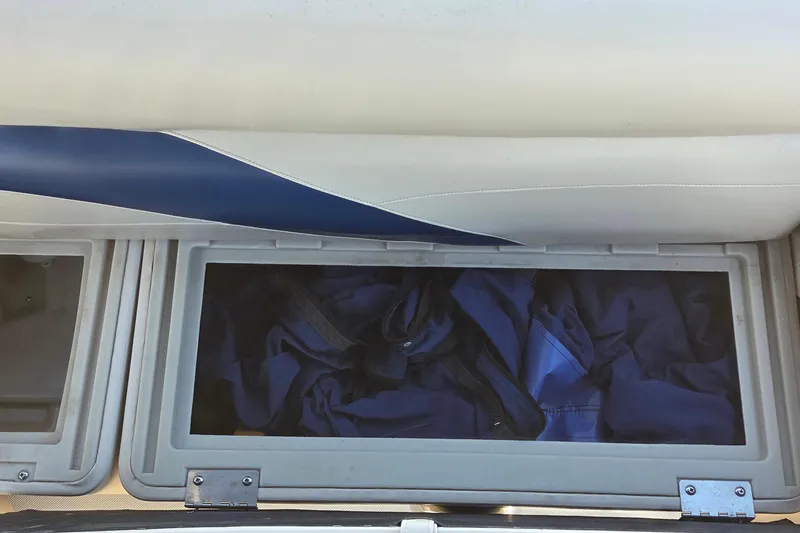 Slide: The Image of Storage compartment in 2014 Hurricane FunDeck 216 OB boat with blue fabric inside. - 12