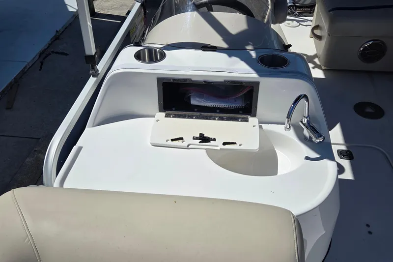 Slide: The Image of 2014 Hurricane FunDeck 216 OB boat interior with sink and cup holders. - 13