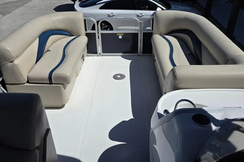 Slide: The Image of 2014 Hurricane FunDeck 216 OB interior with beige seating and blue accents. - 16