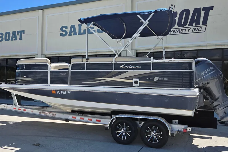 Slide: The Image of 2014 Hurricane FunDeck 216 OB boat on trailer, displayed at sales lot. - 3