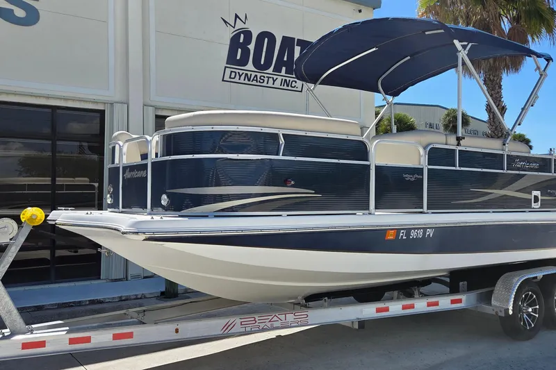 Slide: The Image of 2014 Hurricane FunDeck 216 OB boat on trailer outside dealership. - 4